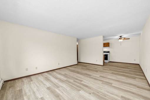 A room with wooden flooring and a ceiling fan.