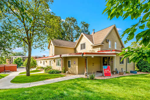 A house with a red sign in front of it.