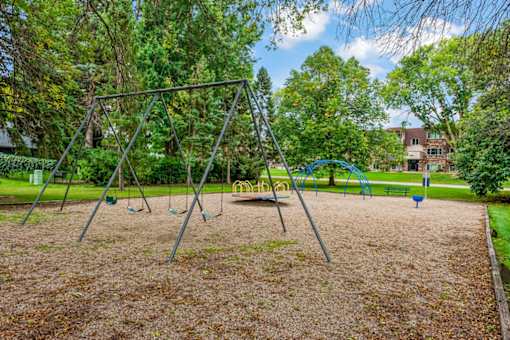 A playground with a swing set and a slide.