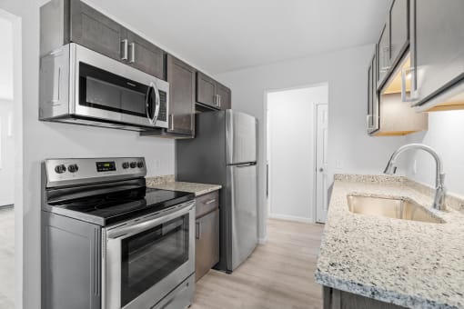 a kitchen with stainless steel appliances and granite counter tops and