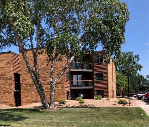 a brick building with a tree in front of it