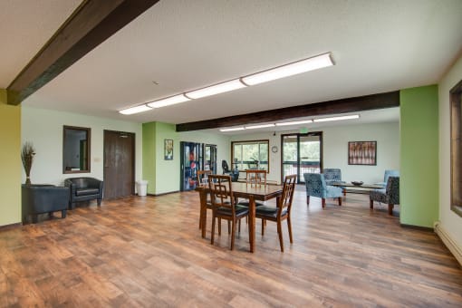 a dining room with a wooden table and chairs
