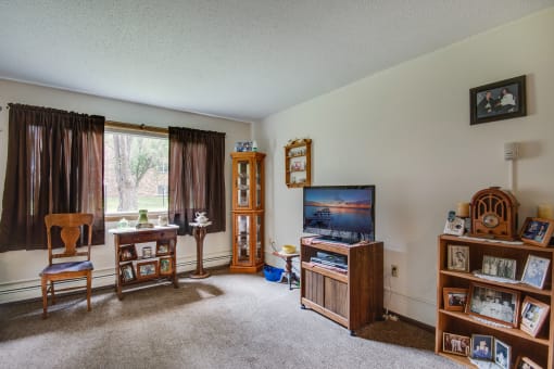 a living room filled with furniture and a tv