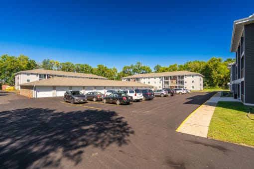 a parking lot with cars in front of a building