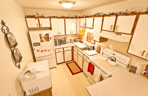 a kitchen with white appliances and white cabinets