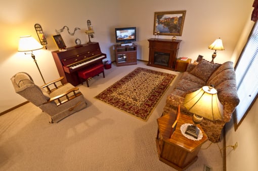 a living room filled with furniture and a piano