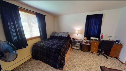 a bedroom with a bed and a fan in it