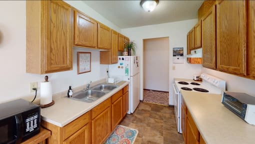 a kitchen with a sink and a refrigerator