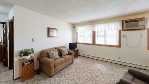 a living room with a couch and a tv
