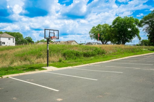 a basketball hoop in an empty parking lot
