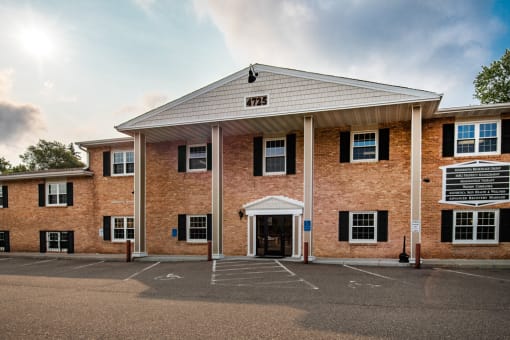 the front of a brick building with a porch