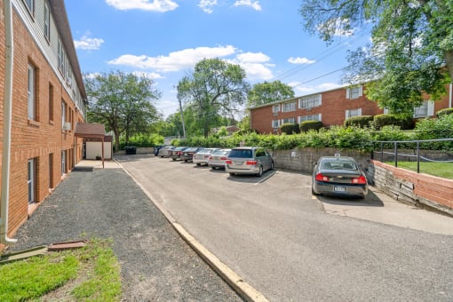 a parking lot with cars in front of a brick building