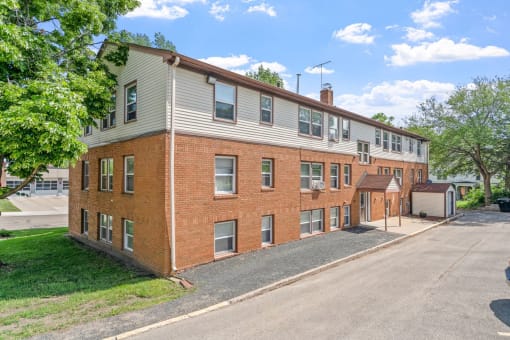 a large brick building with a street in front of it