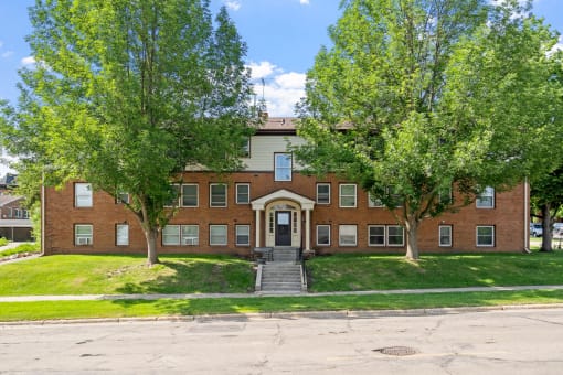 a red brick building with trees in front of it