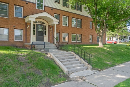a large brick building with stairs in front of it