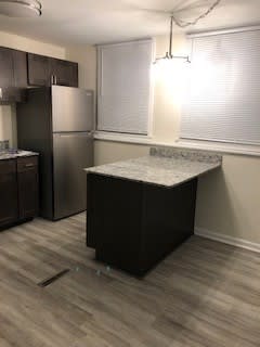 a kitchen with a counter top and a refrigerator