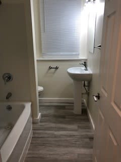a small bathroom with a sink and a bath tub