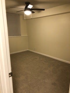 an empty room with a ceiling fan in it