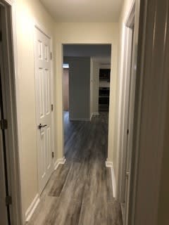 a hallway with a white door and a hall way