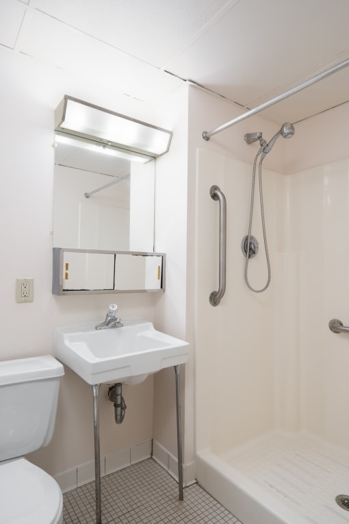 a small bathroom with a sink toilet and shower