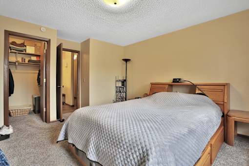 a bedroom with a bed and a closet