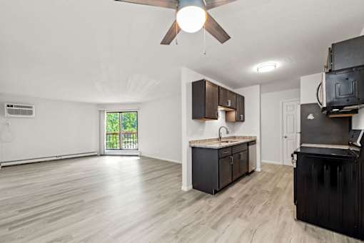 A kitchen with a sink and a ceiling fan.