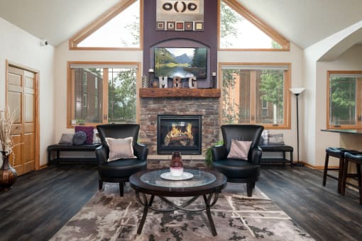 a living room with a fireplace and a table and chairs