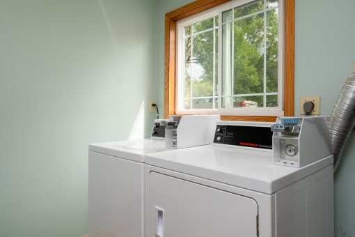 a washer and dryer in a laundry room with a window