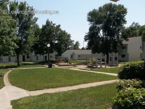 a park with a playground and houses in the