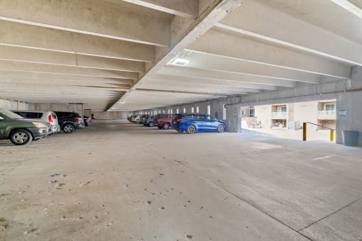 a parking garage with cars parked in it