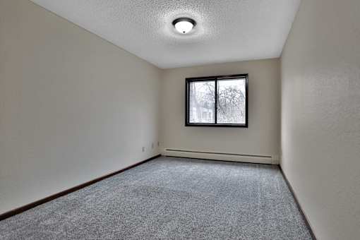 the living room of an empty house with a window