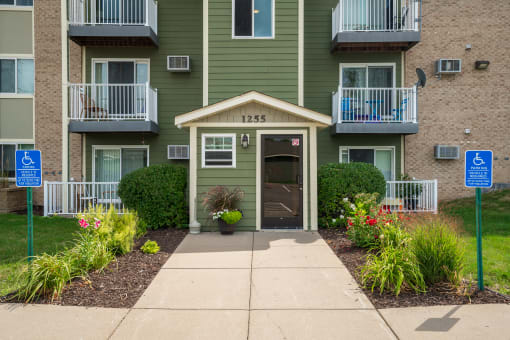 a walkway in front of an apartment building