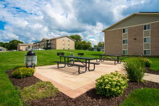 our apartments have a patio with benches and a fire hydrant
