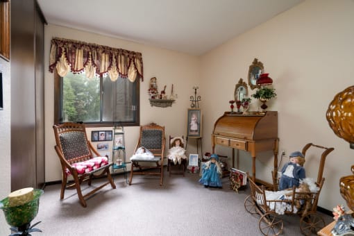 a living room filled with dolls and furniture and a piano