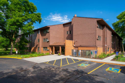 a large brick building with a parking lot in front of it