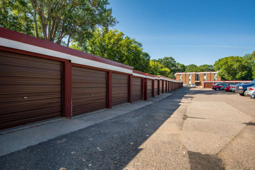 a row of garages with cars parked in front of them