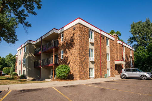 an apartment building with a car parked outside of it