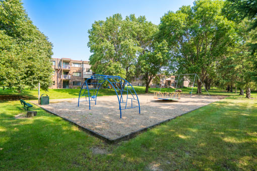 a playground with a swing set in a park