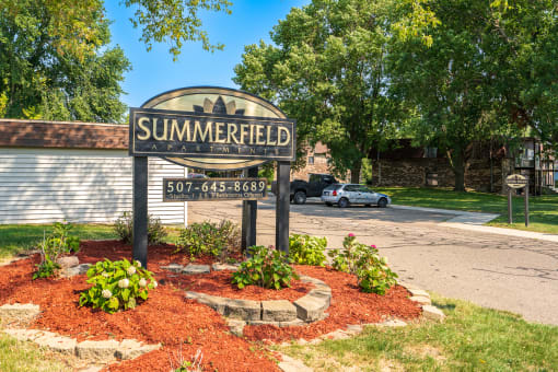 the sign in front of the apartments parking lot