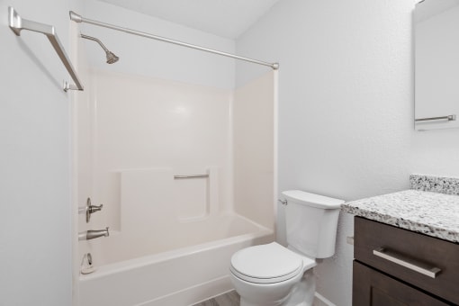 a bathroom with a shower and a toilet and a sink