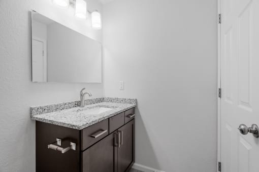 a bathroom with a sink and a mirror