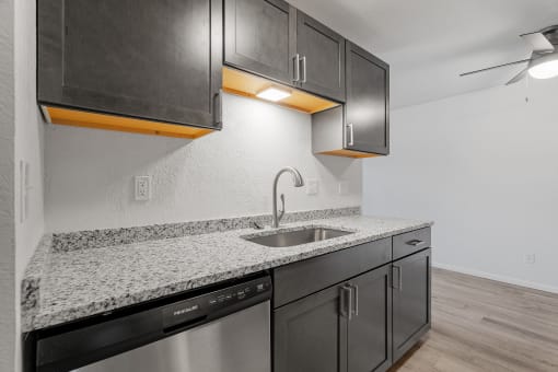 the kitchen of our studio apartment atrium with granite counter top and stainless steel appliances