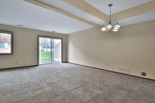 A room with a carpeted floor and a ceiling light.