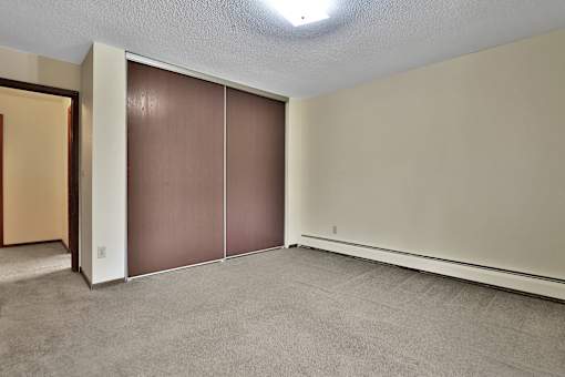 an empty room with a closet and a door