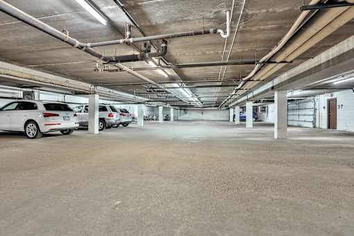 an empty parking garage with cars parked in it