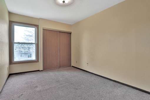 the living room of an empty house with a window and a door