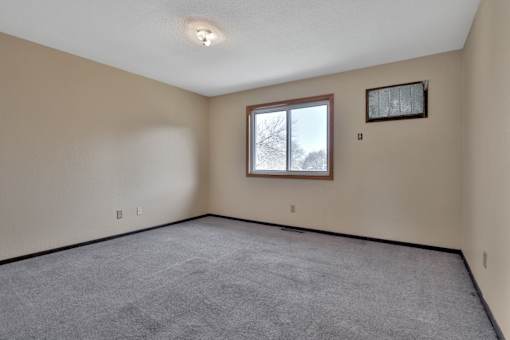 the living room of an empty house with a window