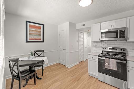 A kitchen with a stove, oven, and cabinets.