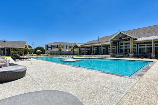 a swimming pool with a building in the background at Estraya Boerne, Texas, 78006