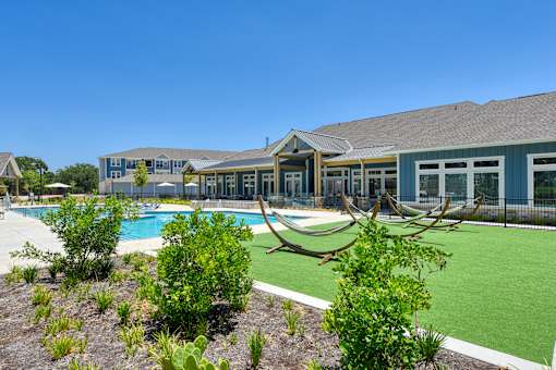 a large building with a pool in front of it at Estraya Boerne, Boerne, TX, 78006